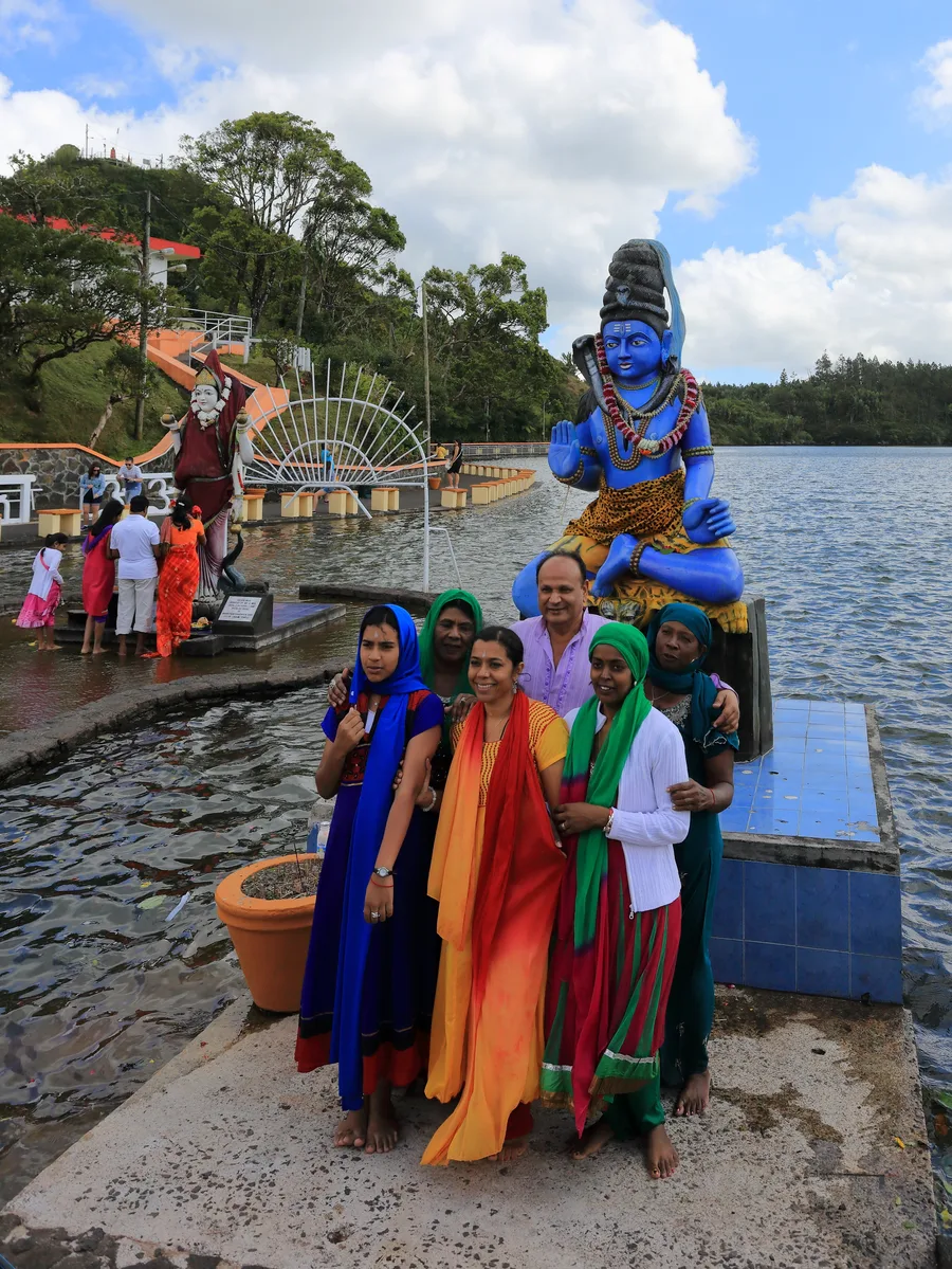 Devotees gathered beside a statue of Shiva at Ganga Talao, the sacred crater lake in Mauritius.