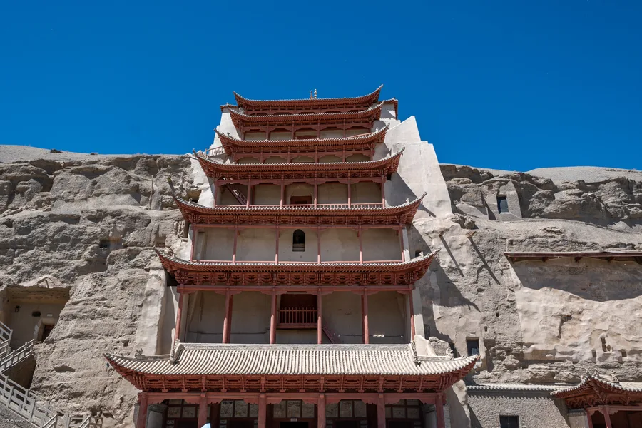 The multi-tiered wooden facade built into the cliffside at the Mogao Caves near Dunhuang, China.