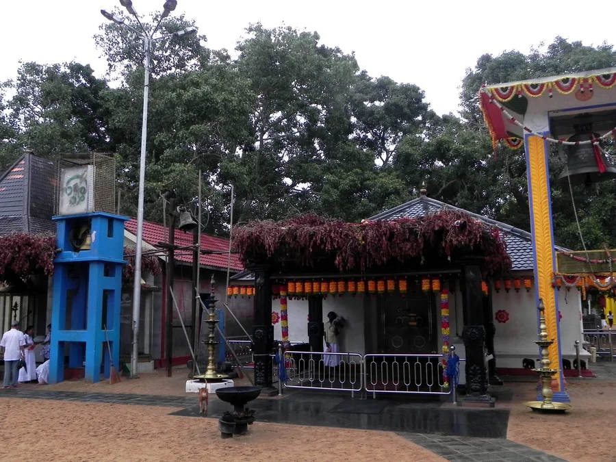 A shrine within the multi-religious Kataragama temple complex in Sri Lanka, decorated with garlands.
