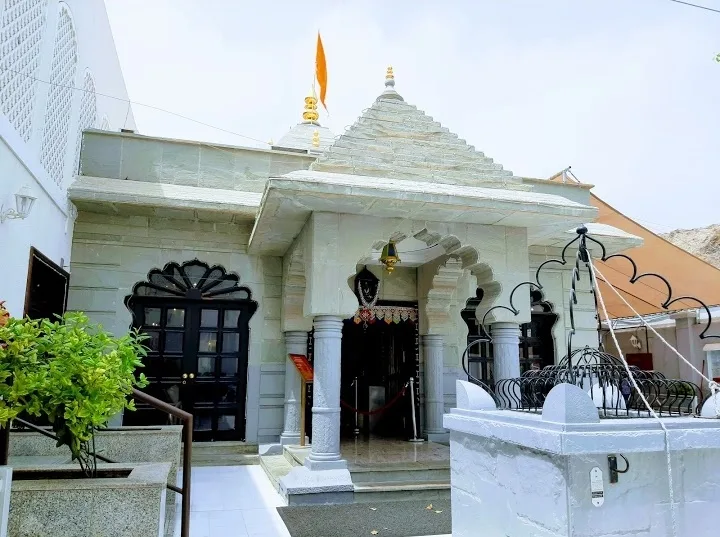 The whitewashed stone facade and entrance arch of the historic Shiva temple in Old Muscat, Oman.