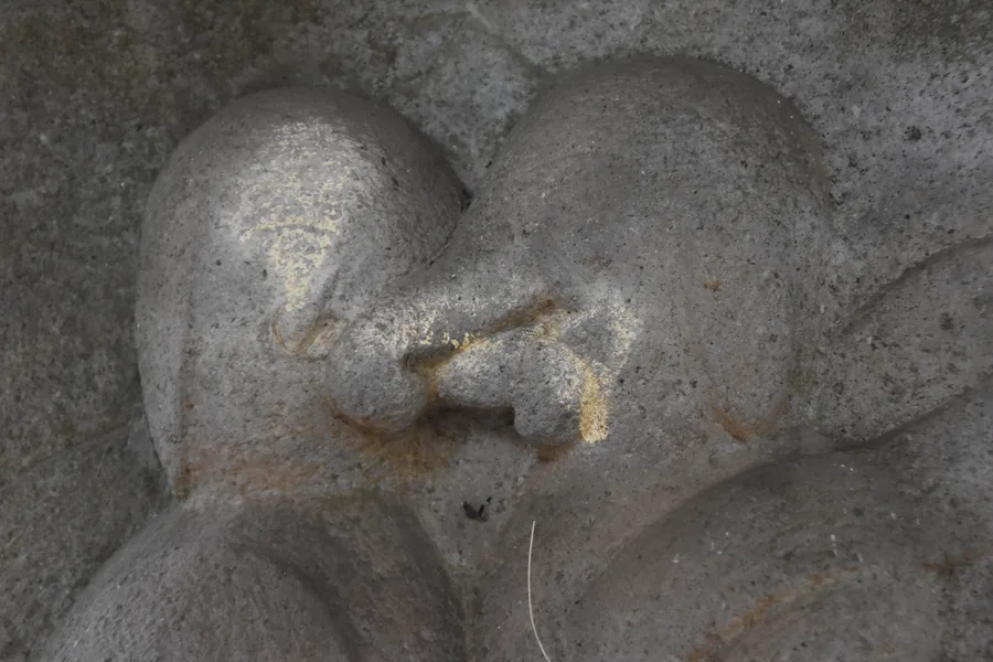 A close-up carving of the embracing Dual Kangiten figures at Torimi Shrine, Japan.