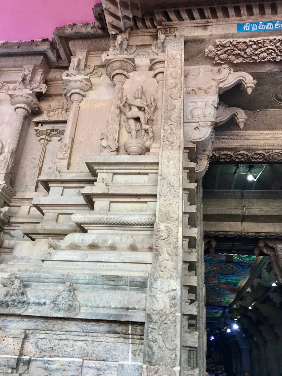 A carved stone relief at the entrance of the rock-cut Karpaka Vinayakar temple in Pillayarpatti.