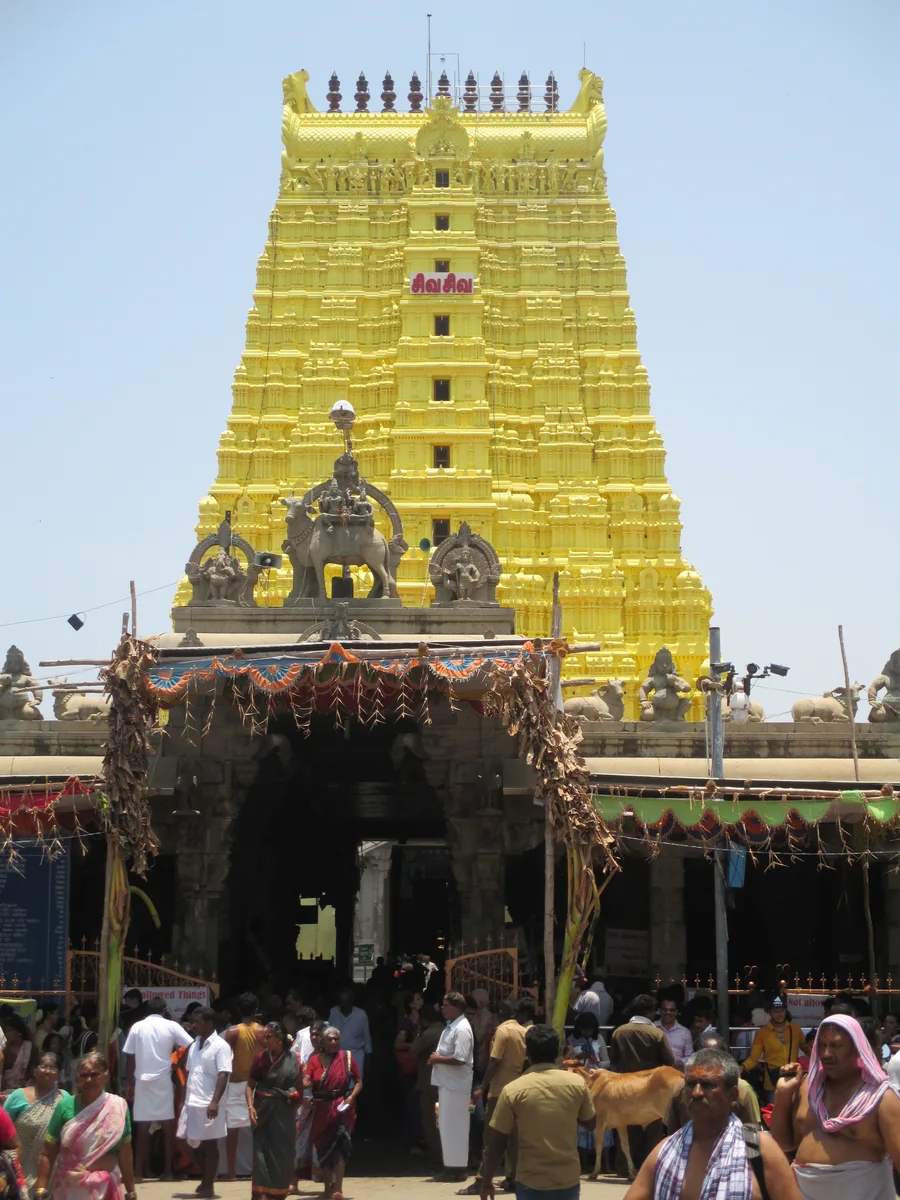 The towering golden gopuram entrance of the Ramanathaswamy Temple at Rameswaram, thronged with devotees.